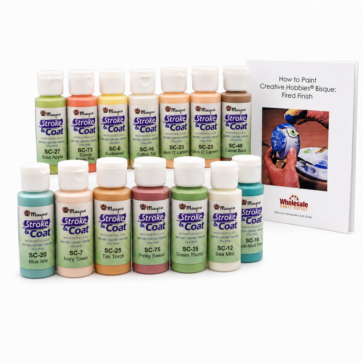 Ceramic underglaze paint bottles in bright colors with partially painted bisque piece and brush